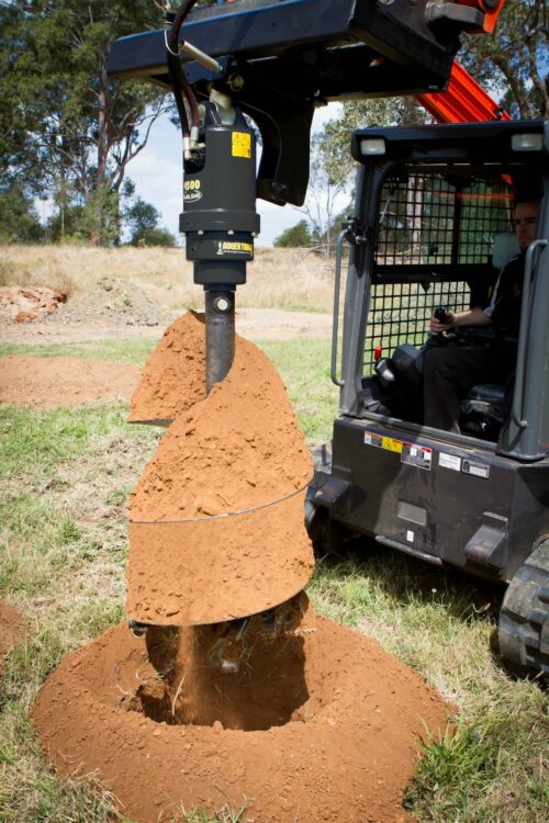 auger drive on skid steer drilling hole